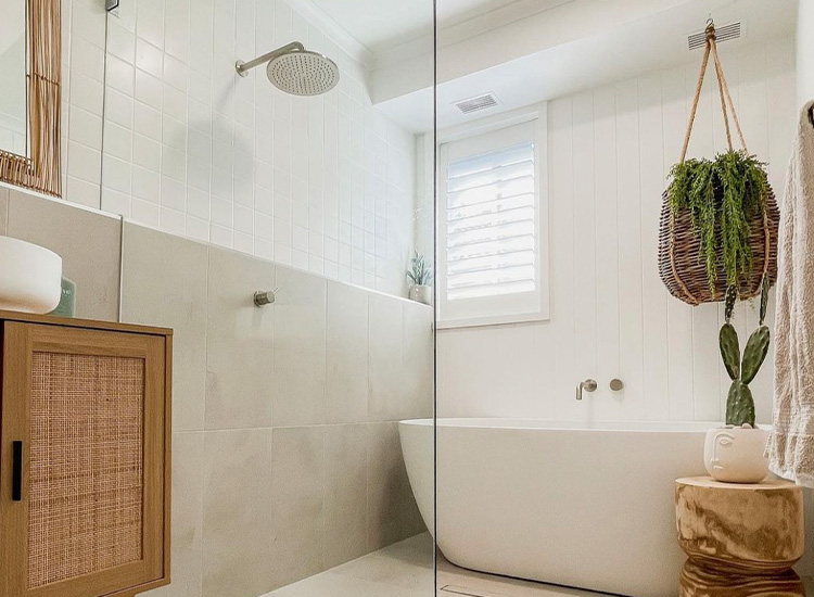 Beautiful coastal bathroom by Katrina Chambers featuring iSeekBlinds plantation shutters.